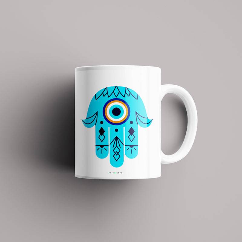 Hamsa Blessing Mug – "Hamsa hand ceramic mug featuring an evil eye symbol, representing luck, spiritual protection, and positivity."